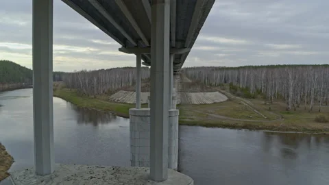 Aerial view of the bridge over the river that cars ride. Stock Footage 132878349