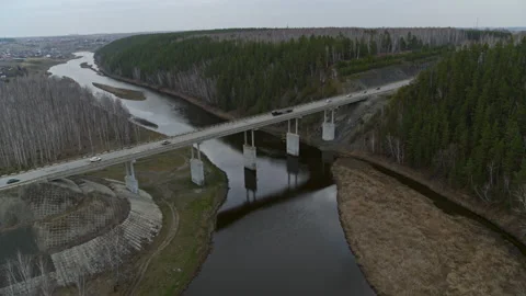 Aerial view of the bridge over the river that cars ride. Video stock 132907471