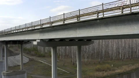 Aerial view of the bridge over the river that cars ride. Video stock 134083364