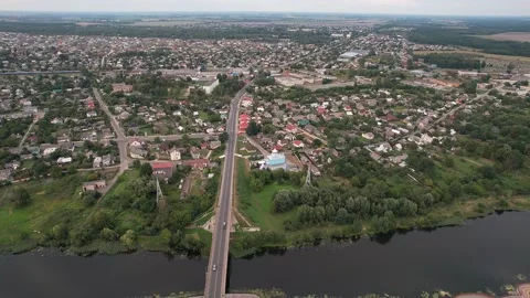Aerial view of the bridge over the river and city blocks with with residential Stock-Footage 225444416