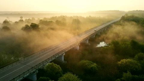 Aerial view of the bridge over the river on a foggy morning Stock Footage 231691764