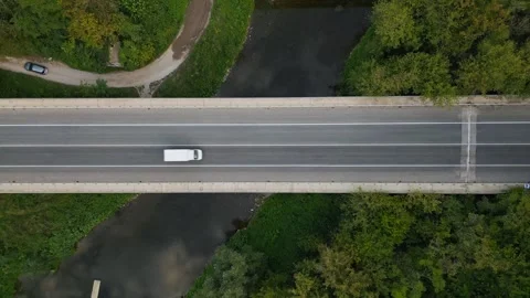 Aerial view of a bridge over the river, with cars zooming across, creating a Stock Footage 250998024