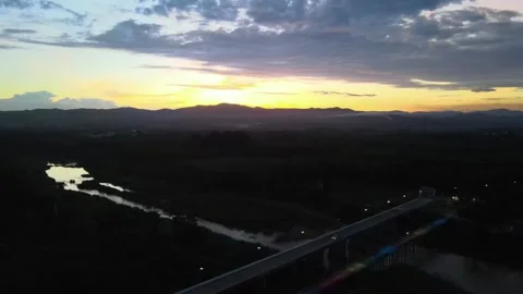Aerial View of Bridge Over River at Sunset with Mountain Silhouette Video stock 308228885