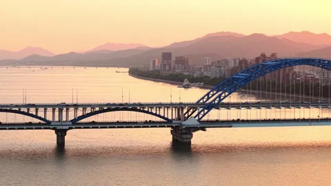 Aerial view of a bridge over a river with cars commuting at sunset. Hangzhou Stock Footage 308845045