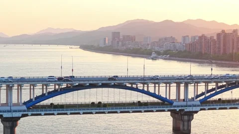 Aerial view of a bridge over a river with cars commuting at sunset. Hangzhou 스톡 동영상 309799223