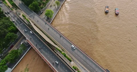 Aerial View of Bridge Over River in Vibrant City with Vehicles, Boats, Urba.. Stock Footage 315933187