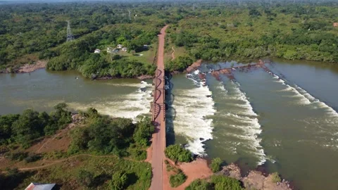 Aerial view of a bridge over a river with a small waterfall in guinea Stock Footage 318490939