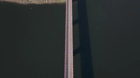 Aerial view of a bridge over the river, rising above the road and the landscape Vídeos de archivo 321764786