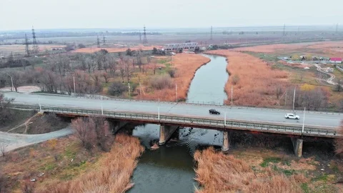 Aerial view of a bridge over a small river in the countryside Stock Footage 127513228