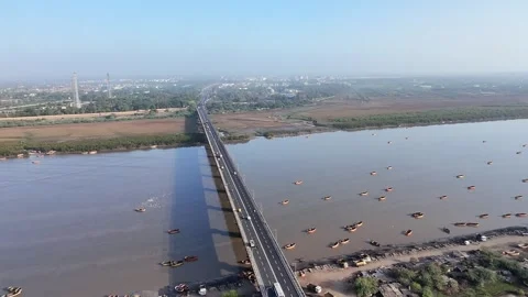 Aerial view of bridge over Tapi River with boats and water landscape in Surat Stock Footage 332670598