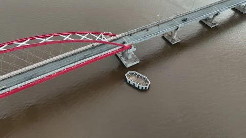 Aerial view of the bridge with red and white paint stretching across it Stock Footage 327543451