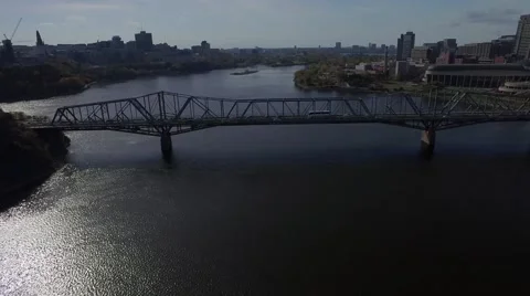 Aerial view of bridge reverse tracking shot of cars city and water Stock Footage 56329449