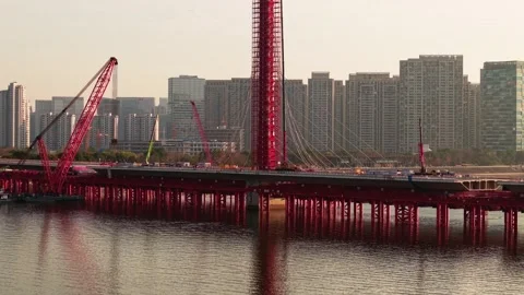 Aerial view of bridge sections being dismantled with a large crane over a river 스톡 동영상 335644038