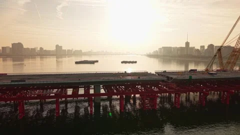 Aerial view of bridge sections being dismantled with a large crane over a river Video stock 335644054