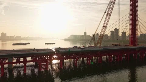 Aerial view of bridge sections being dismantled with a large crane over a river Video stock 335644055