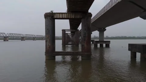 Aerial view of bridge support pillars standing in river water in Bharuch Stock Footage 345493778