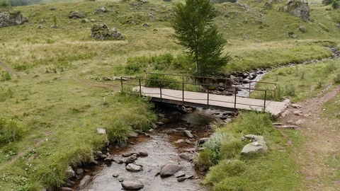 Aerial View on bridge through stream with Green vegetation on mountains or Video stock 119350900