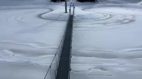 Aerial view of a bridge under snow in Meribel, French alps, under the ski lifts Stock Footage 337245876