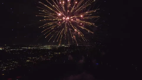 Aerial view of bright fireworks exploding with colorful lights over sea shore on Stock Footage 210233248