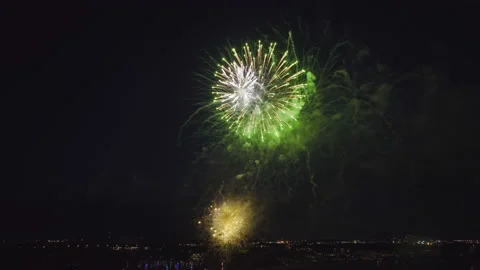 Aerial view of bright fireworks exploding with colorful lights over sea shore on Stock Footage 218667911
