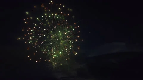 Aerial view of bright fireworks exploding with colorful lights over sea shore on Stock Footage 219441952
