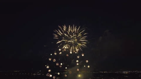 Aerial view of bright fireworks exploding with colorful lights over sea shore on Video stock 220629108