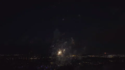 Aerial view of bright fireworks exploding with colorful lights over sea shore on Stock Footage 228595358
