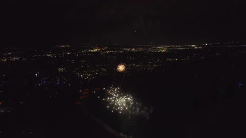 Aerial view of bright fireworks exploding with colorful lights over sea shore on Video stock 229540013