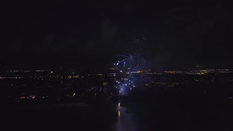 Aerial view of bright fireworks exploding with colorful lights over sea shore on Video stock 232227749