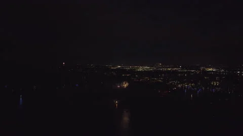 Aerial view of bright fireworks exploding with colorful lights over sea shore on Stock Footage 232625556