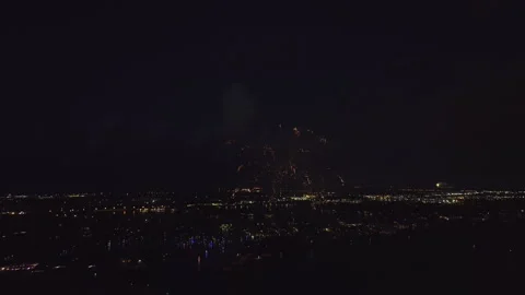 Aerial view of bright fireworks exploding with colorful lights over sea shore on Stock Footage 243645102
