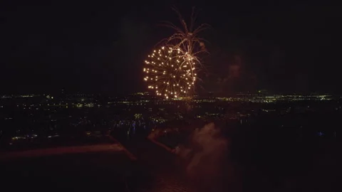 Aerial view of bright fireworks exploding with colorful lights over sea shore on Video stock 258843308