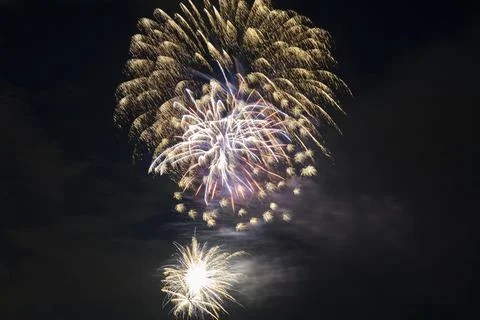 Aerial view of bright fireworks exploding with colorful lights against dark Stock Photos