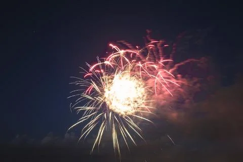 Aerial view of bright fireworks exploding with colorful lights against dark Stock Photos
