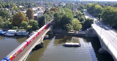 Aerial view of brightly colored train crossing Richmond railway bridge London Video stock 80291844