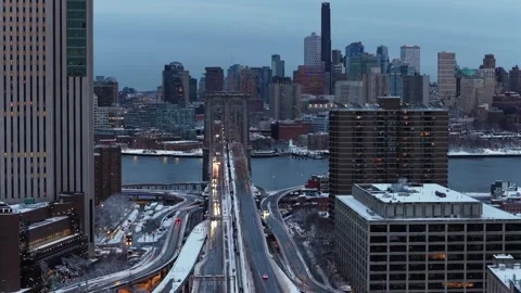 Aerial view of Brooklyn Bridge and Manhattan skyline in winter, traffic flowing Stock Footage 333330611