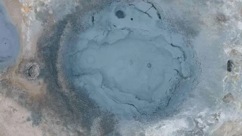 Aerial view of a bubbling mud pot in a geothermal area, steaming and abstra.. Stock Footage 337282748