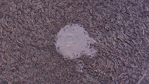Aerial view of bubbling mud volcano crater at Paclele Mici, Romania. Stock Footage 333215413