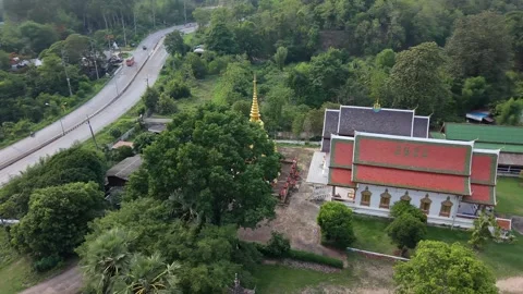 Aerial view of Buddhist monastery and highway in Asia Stock Footage 335418905
