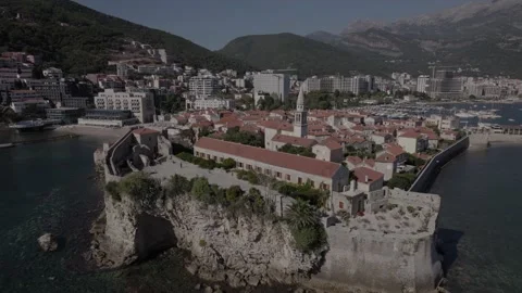 Aerial View Of Budva Old Town Tower And Pier, Montenegro Video stock 230106321