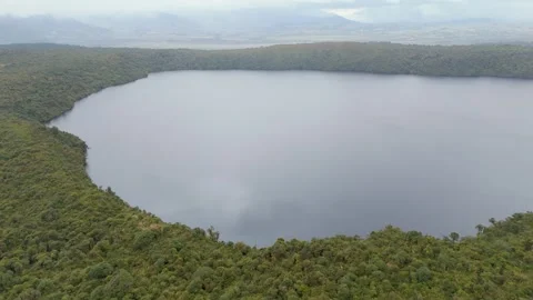 Aerial View of Buey Lagoon Surrounded by Lush Greenery Vídeo Stock 330759995