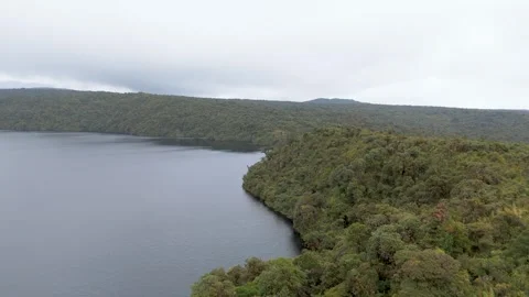 Aerial view of Buey Lagoon surrounded by lush forest Stock Footage 330760076
