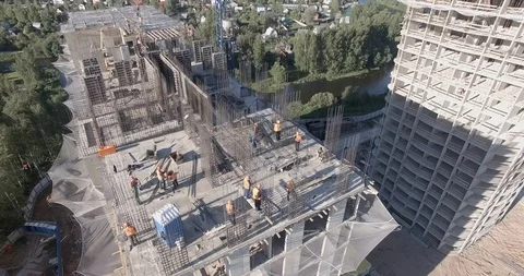 Aerial view on builders of a multistory building install rebar grid at a height 스톡 동영상 105080167