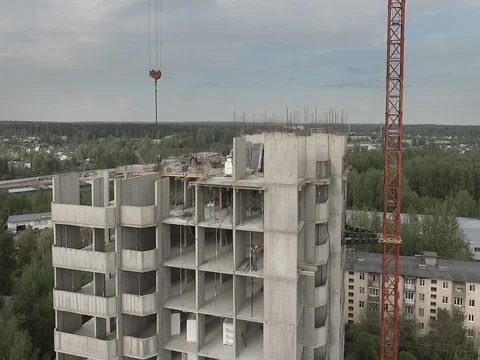 Aerial view on builders working  on the upper floors of the block houses Stock Footage 76102799