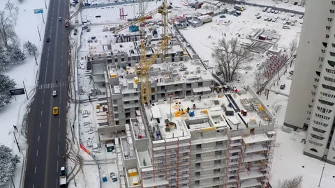 Aerial view of building construction site in winter Stock Footage 100961797