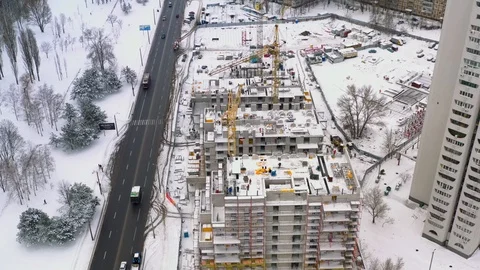 Aerial view of building construction site in winter Stock Footage 100961817