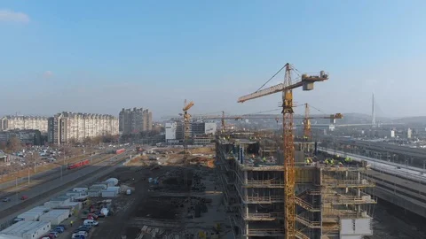 Aerial view of building construction site with crane and workers Stock Footage