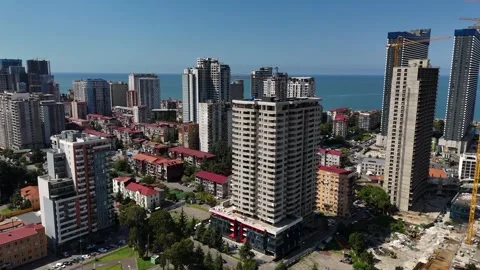 Aerial view of the building construction site overlooking the city and the sea Stock Footage 290022594
