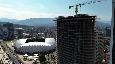 Aerial view of the building construction site overlooking the stadium Stock Footage 290022713