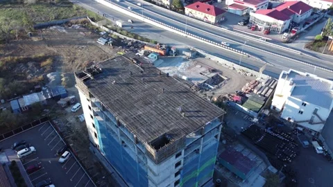 Aerial view of a building under construction in the suburbs Stock Footage 163337835